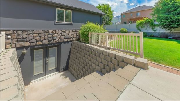 walkout basement entrance with double doors and stairwell