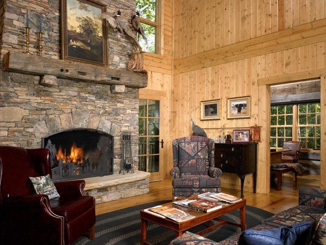 A living room with a fireplace , chairs , and a coffee table.
