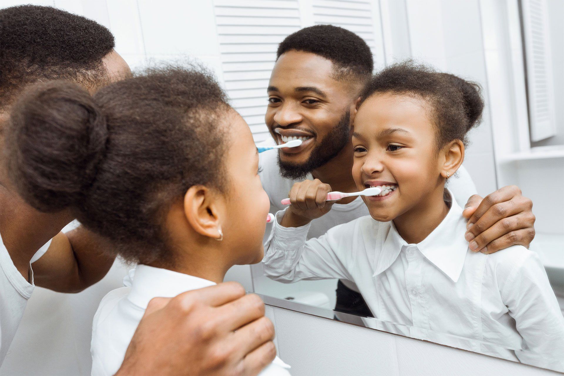 Father And Daughter Brushing Teeth — Edina, MN — Interlachen Dental Associates