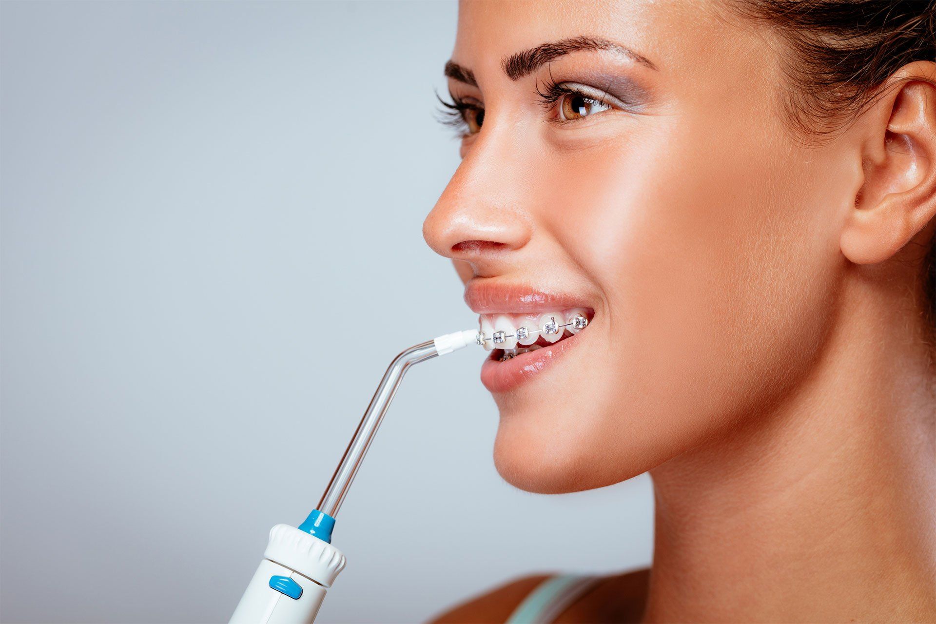 Youn Woman Cleaning Her Teeth — Edina, MN — Interlachen Dental Associates