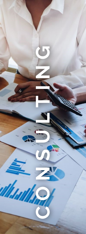 A woman is sitting at a table with papers and a calculator.