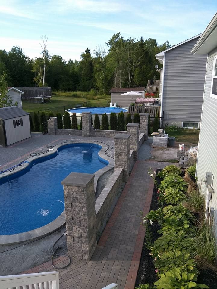 A large swimming pool in the backyard of a house
