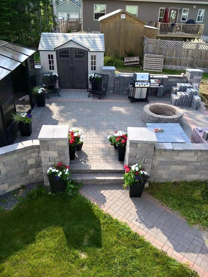 An aerial view of a backyard with a fire pit and a shed.