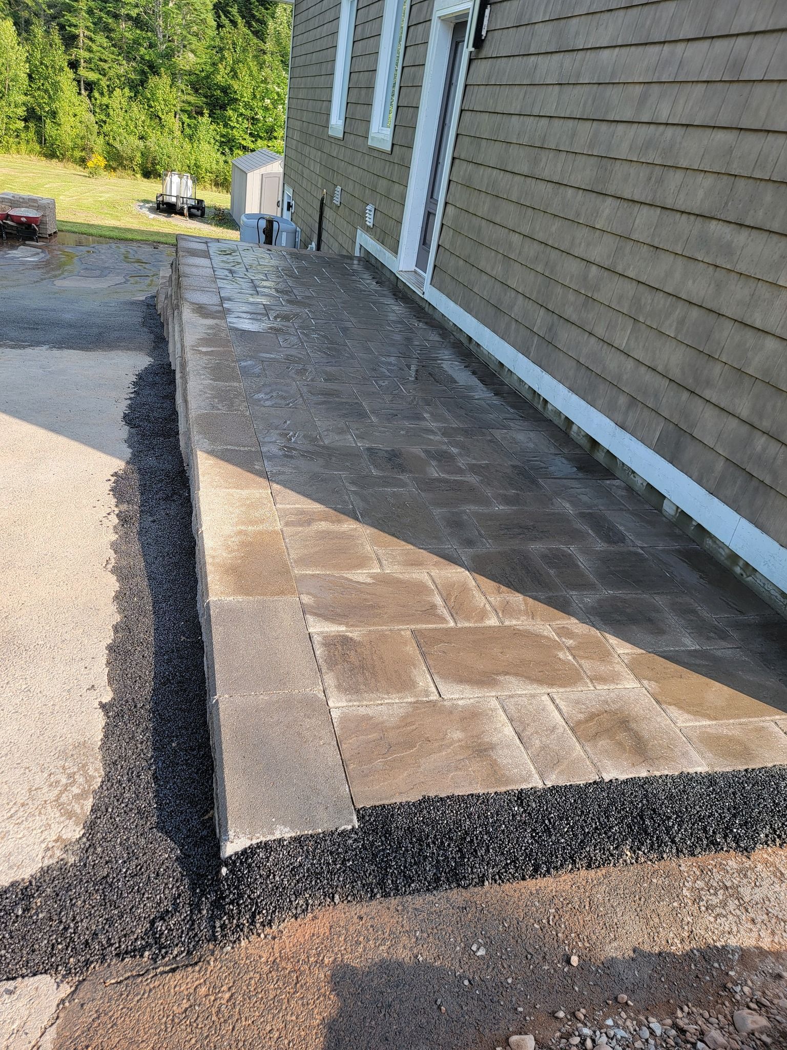 A sidewalk is being built in front of a house.