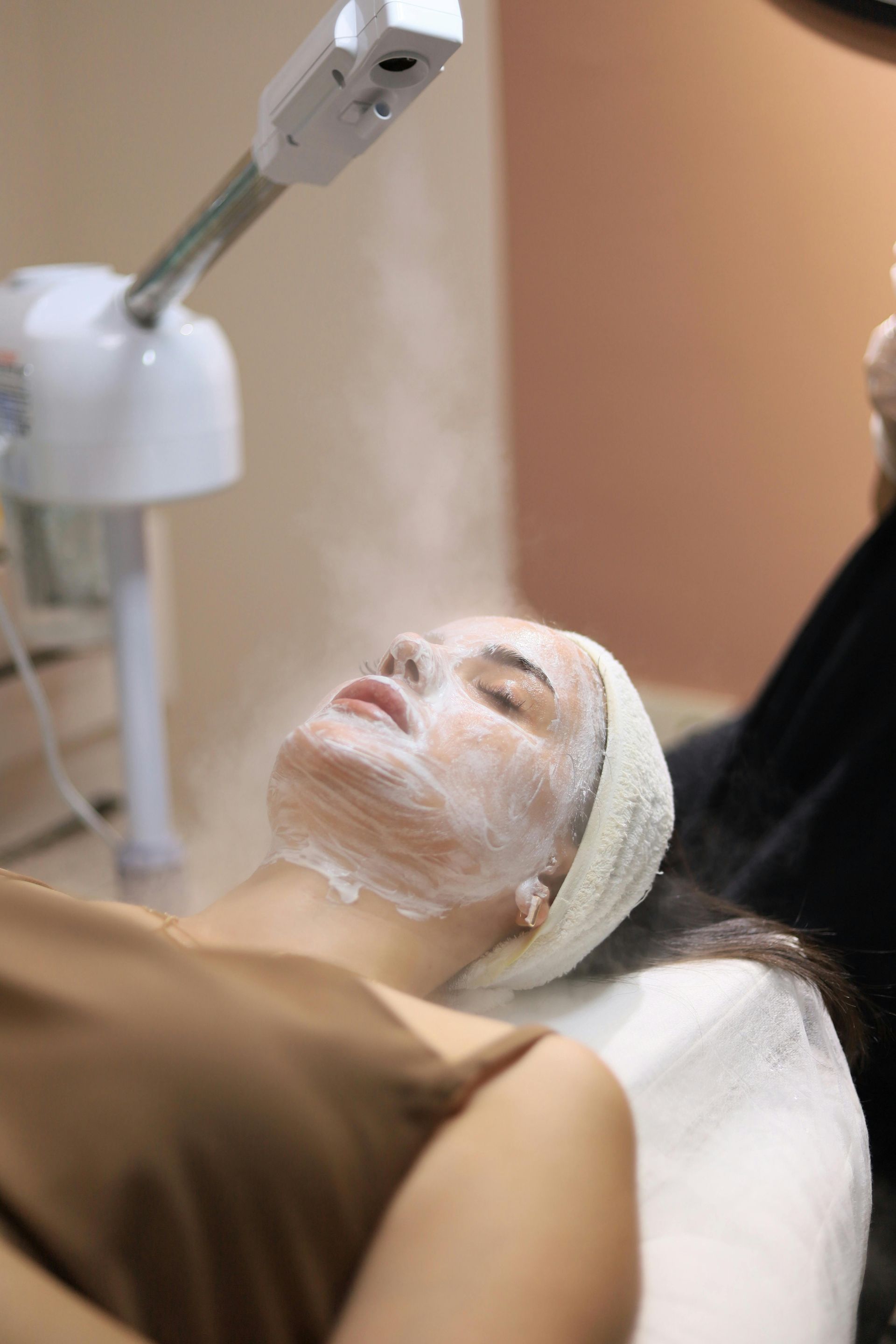 A woman is getting a facial treatment in a beauty salon.