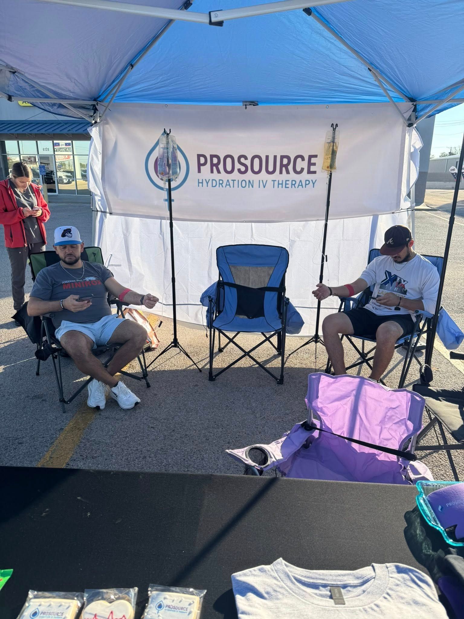 Two men sit at an outdoor booth with 