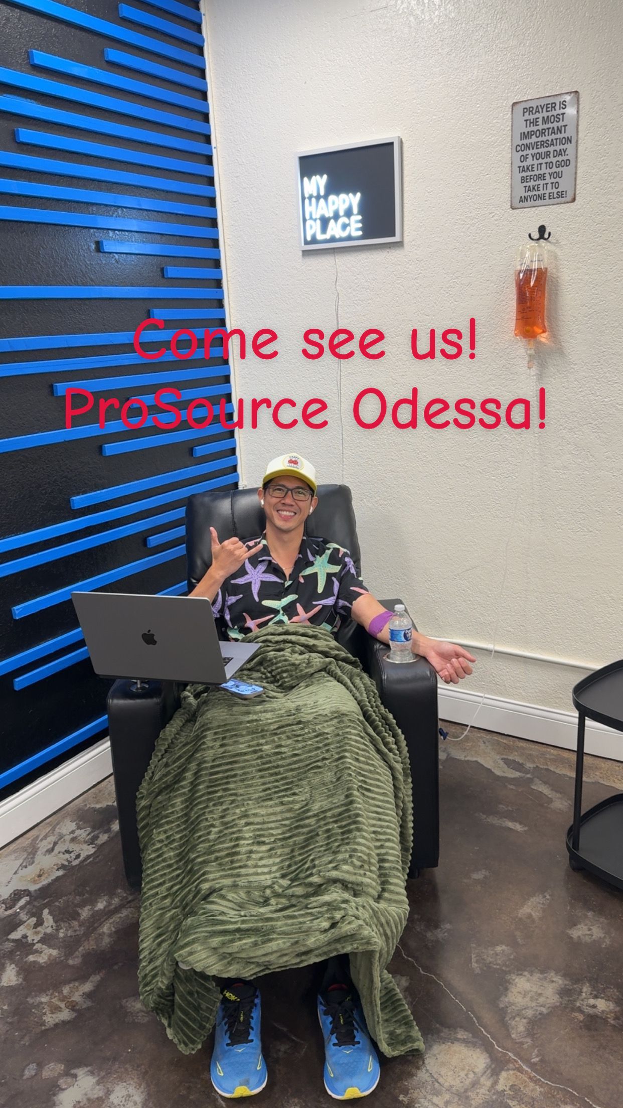 Person in chair, laptop in lap, blanket, text: 