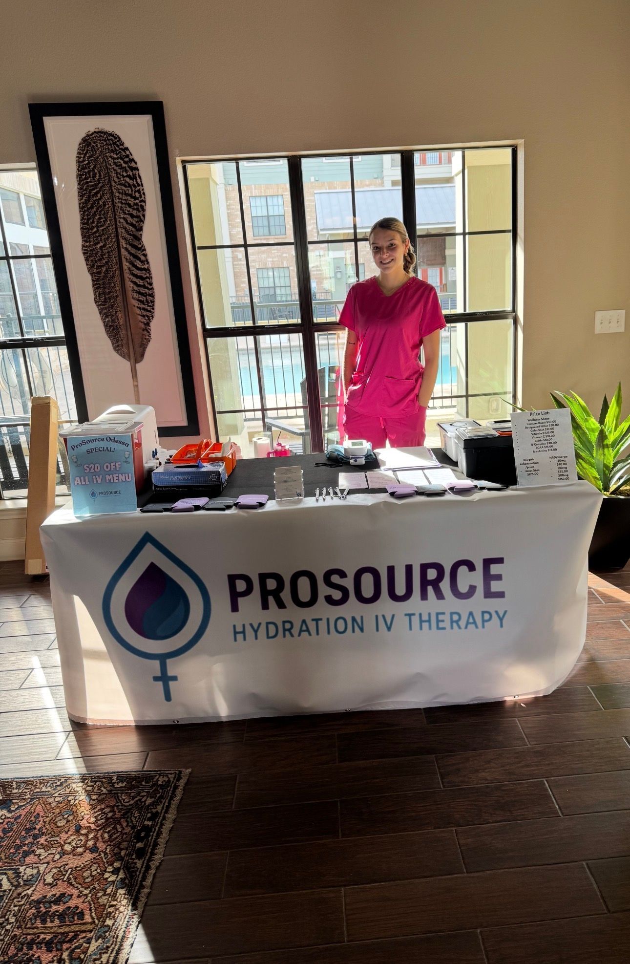 Woman stands behind a table with 