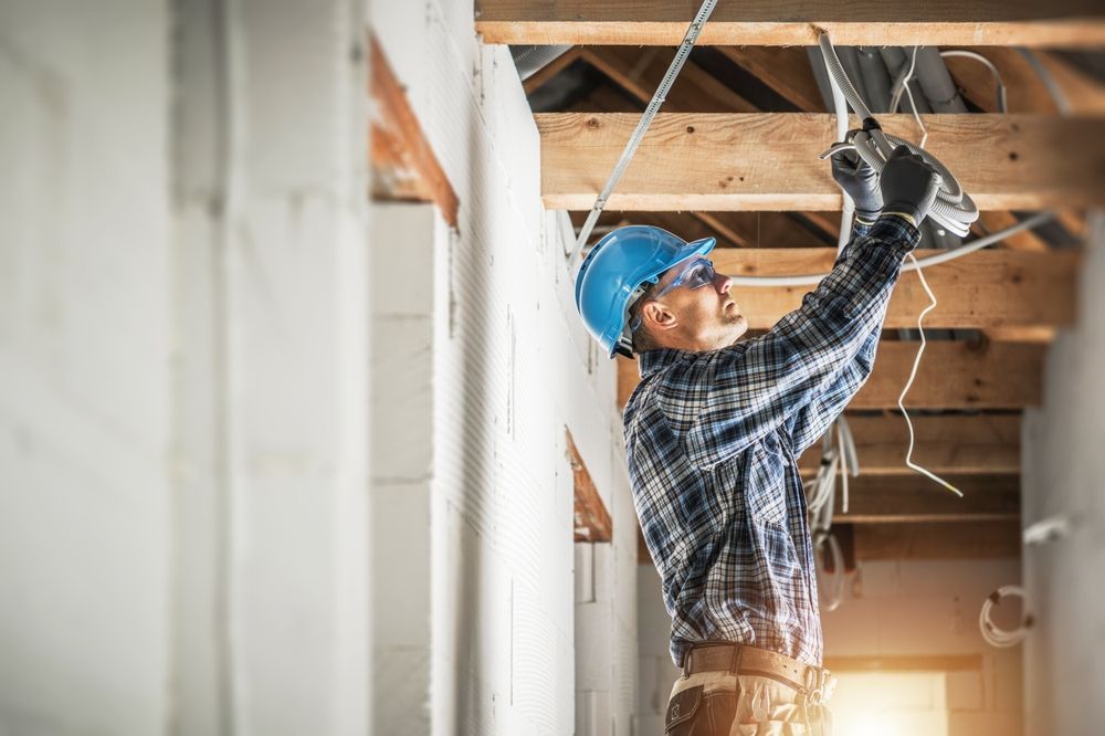 A man is working on the ceiling of a building.