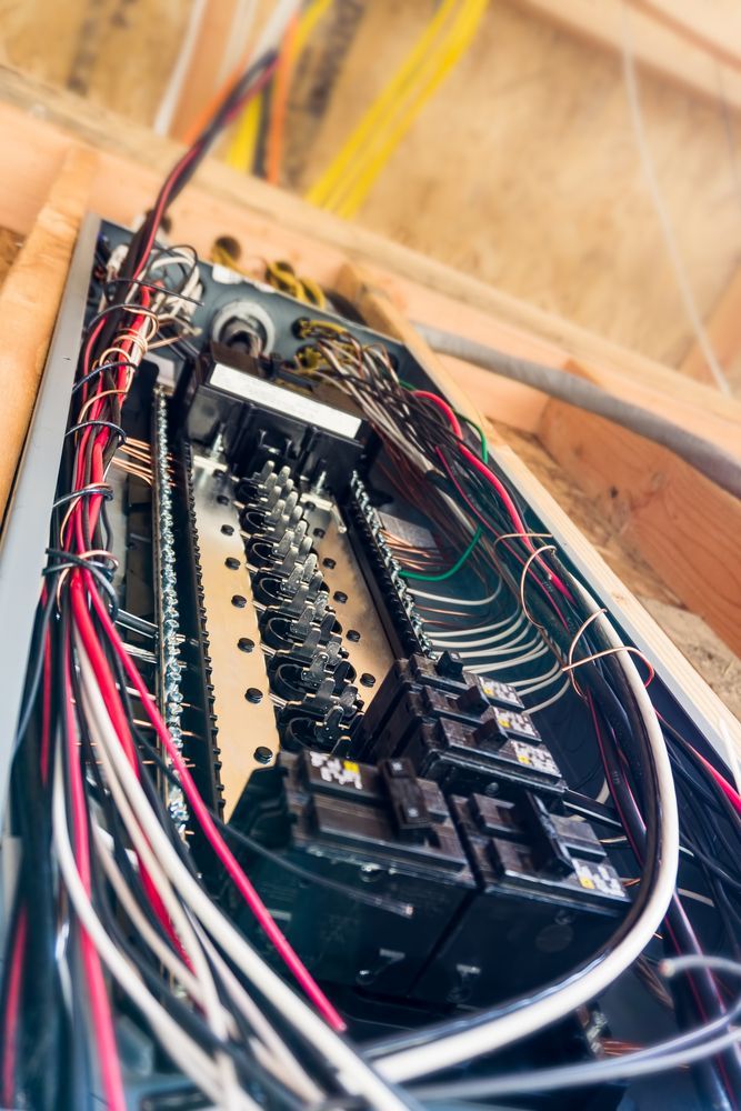 A close up of a electrical box with wires coming out of it.