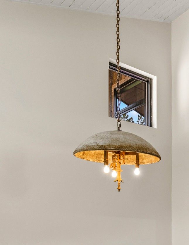 Hanging dome pendant light with warm bulbs in a white interior room