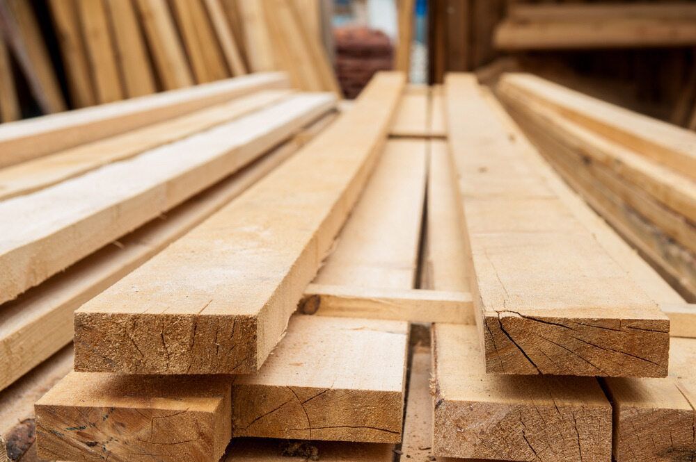 A Pile of Wooden Boards Stacked on Top of Each Other — Flow Kitchens in Hallidays Point, NSW