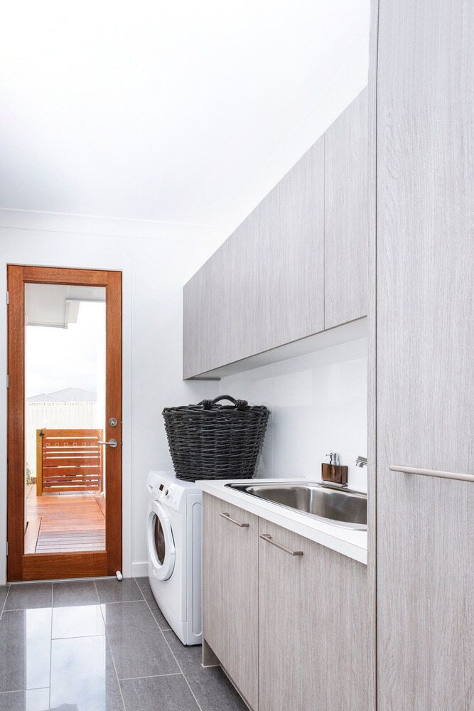 A Laundry Room With a Washer and Dryer and a Sink — Flow Kitchens in Hallidays Point, NSW