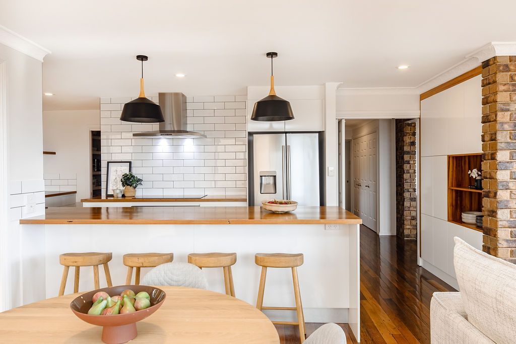 Kitchen With a Wooden Countertop, Stools, and Pendant Lights — Flow Kitchens in Taree South, NSW
