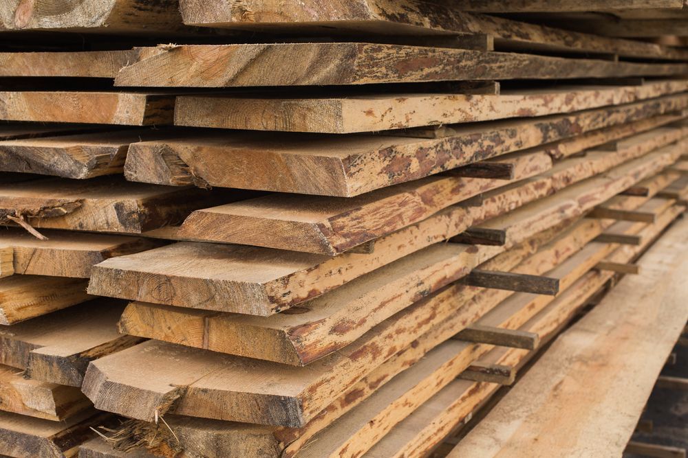 A Pile of Wooden Boards Stacked on Top of Each Other — Flow Kitchens in Gloucester, NSW