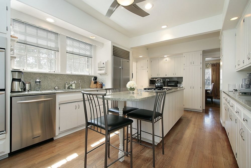 A Kitchen Under Construction With White Cabinets and Wooden Counter Tops — Flow Kitchens in Taree South, NSW