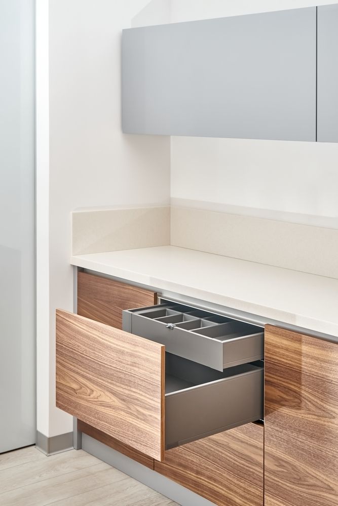 A Kitchen With Wooden Cabinets and a Stainless Steel Drawer Open — Flow Kitchens in Gloucester, NSW