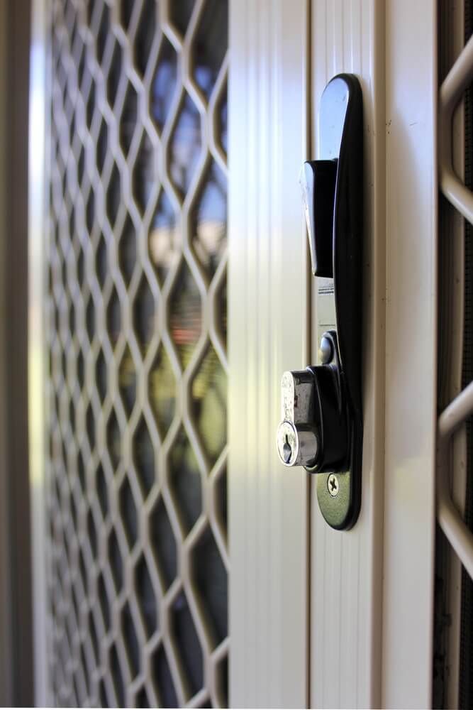 A close up of a screen door with a lock on it — Flow Kitchens in Gloucester, NSW