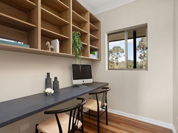 Home Office With Wooden Shelving, Desk, and a Window Overlooking Trees — Flow Kitchens in Taree South, NSW