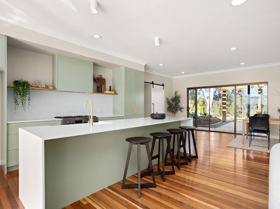 Modern Kitchen With Sage Green Cabinets, White Countertops, and Wooden Floors — Flow Kitchens in Taree South, NSW