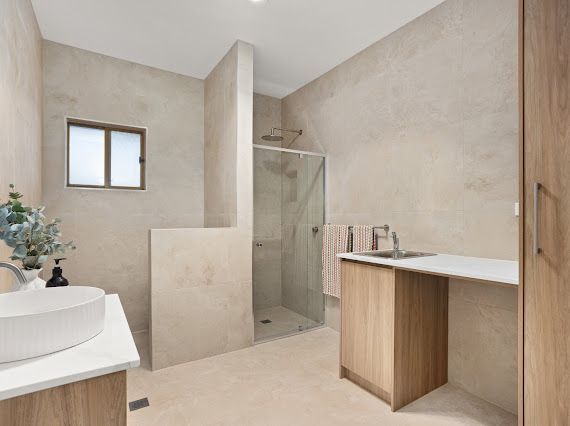 A Laundry Room With a Washer and Dryer and a Sink — Flow Kitchens in Taree South, NSW