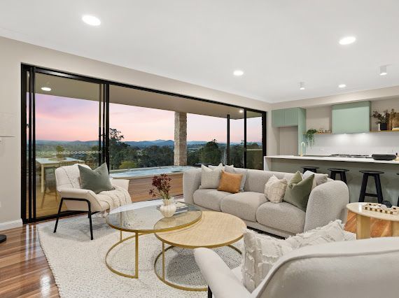 Living Room With Sliding Glass Doors Overlooking a Sunset — Flow Kitchens in Taree South, NSW