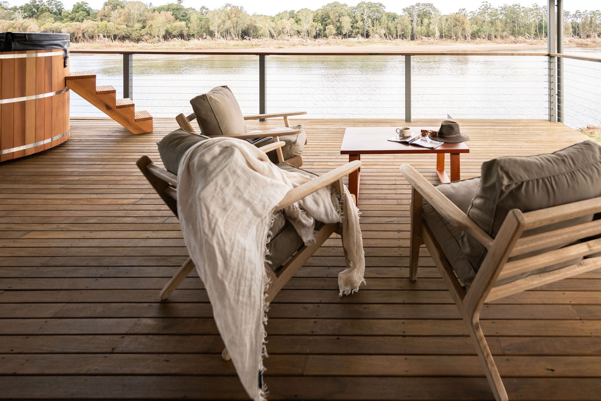 A large wooden deck with a view of a valley and a house in the background — Flow Kitchens in Taree South, NSW