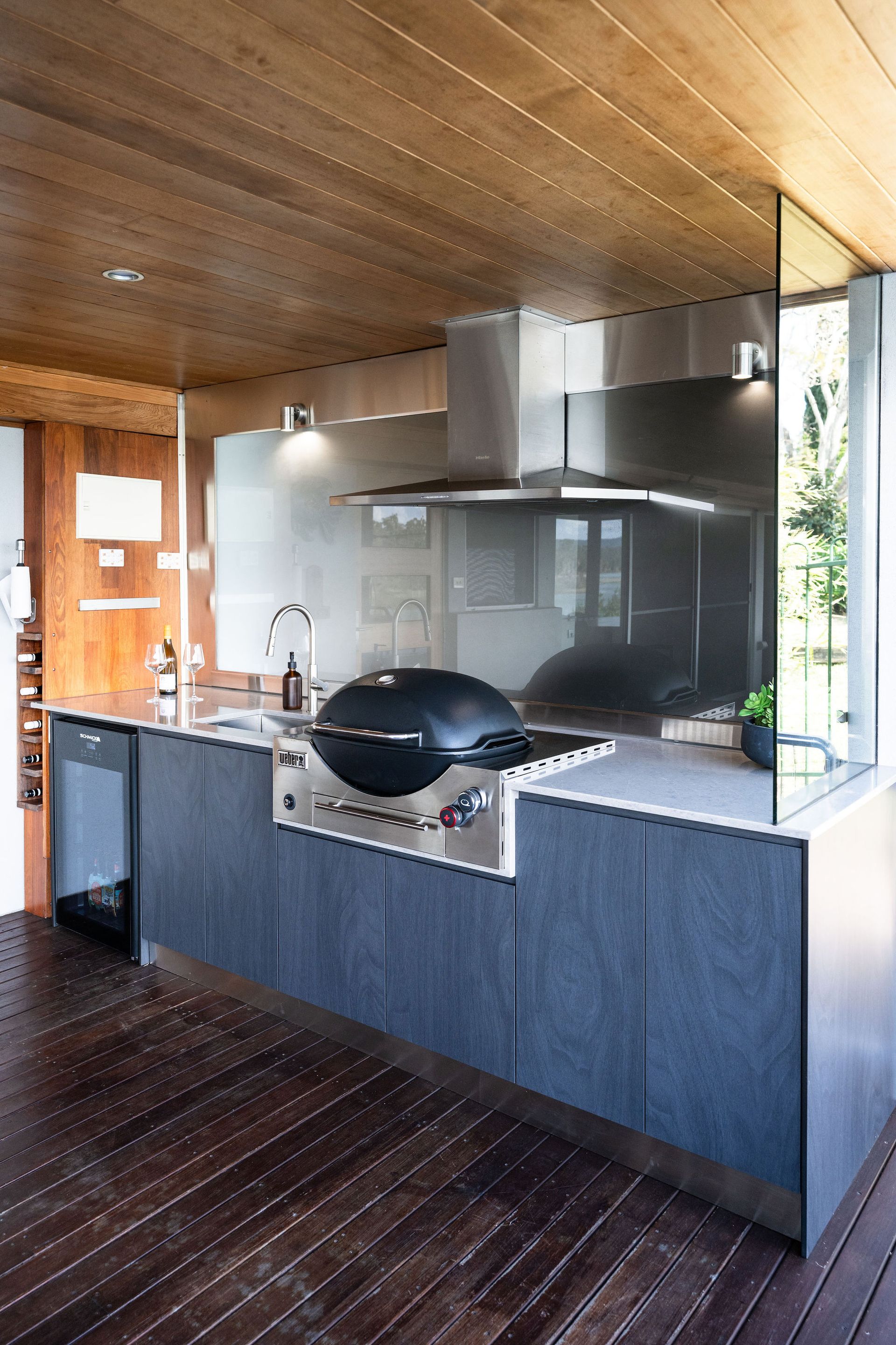 Outdoor Kitchen With Stainless Steel Grill, Gray Cabinetry, Wooden Ceiling and Floor — Flow Kitchens in Taree South, NSW