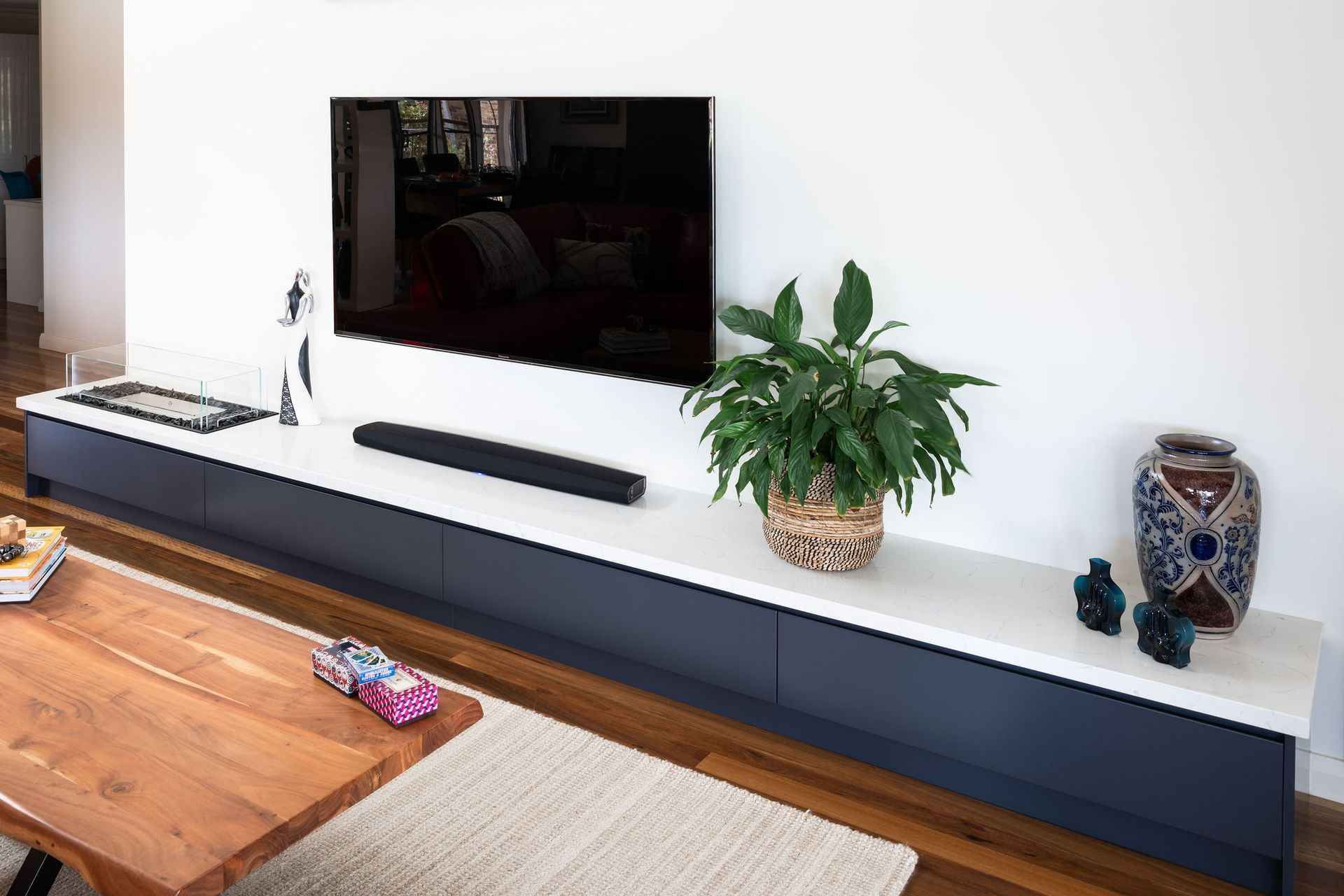 Built-in Media Console With a Tv Above, Holding Plants and Decor — Flow Kitchens in Taree South, NSW