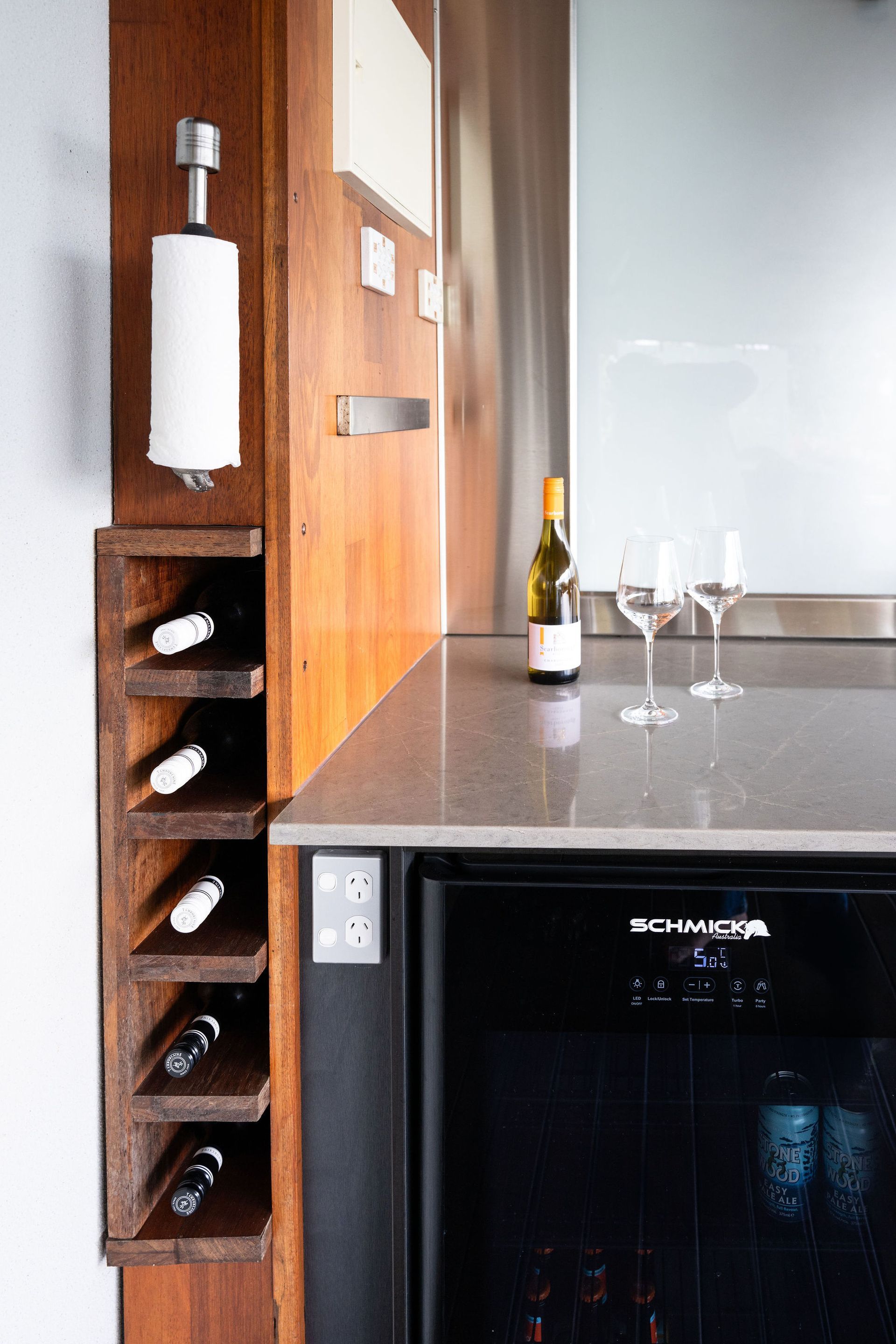 Wine Bar With a Wooden Wine Rack, Built-in Refrigerator, Countertop, and Wine Glasses — Flow Kitchens in Taree South, NSW