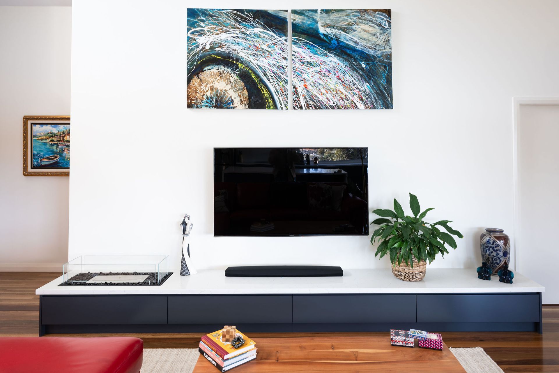 Living Room With Tv, Artwork, and White and Blue Media Console — Flow Kitchens in Taree South, NSW