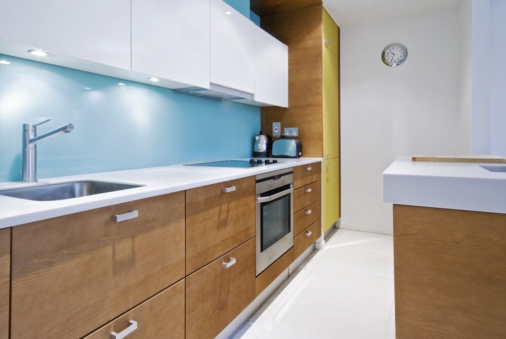 A Kitchen With Wooden Cabinets and White Counter Tops — Flow Kitchens in Wingham, NSW