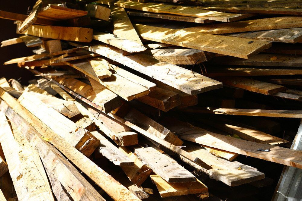 A Pile of Wood is Stacked on Top of Each Other — Flow Kitchens in Hallidays Point, NSW