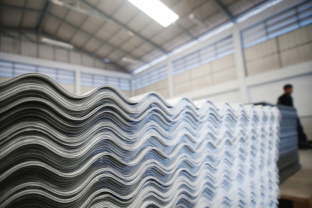 A Stack of Corrugated Metal Sheets in a Warehouse — Flow Kitchens in Forster, NSW