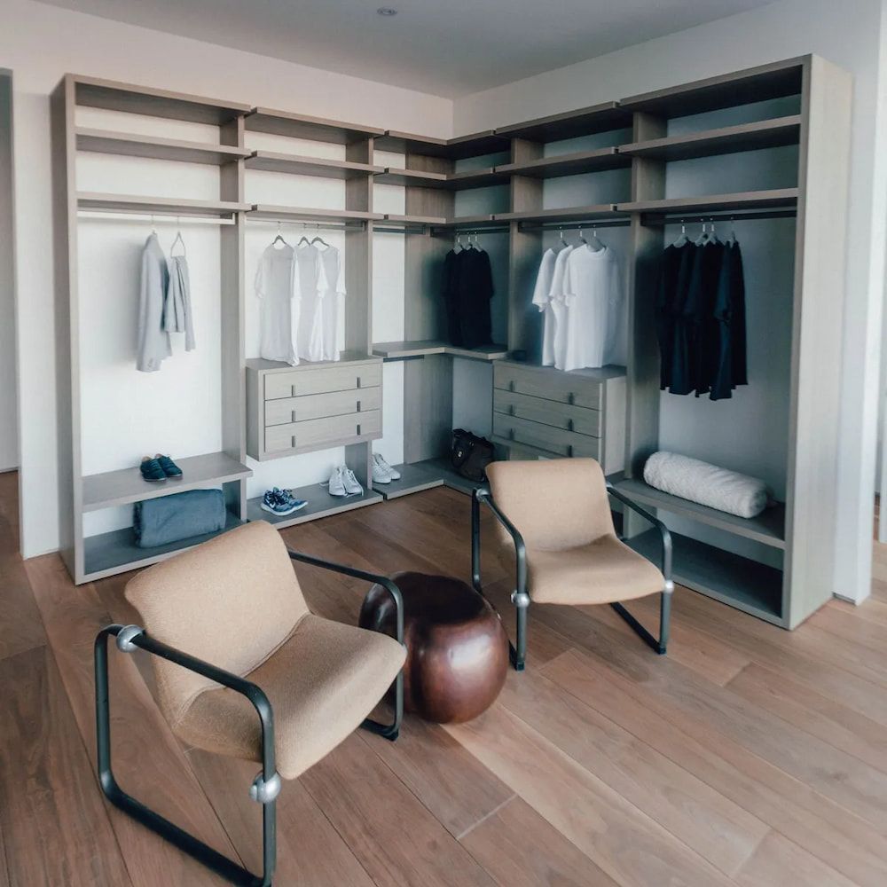 A Walk in Closet With Two Chairs and a Coffee Table — Flow Kitchens in Taree South, NSW