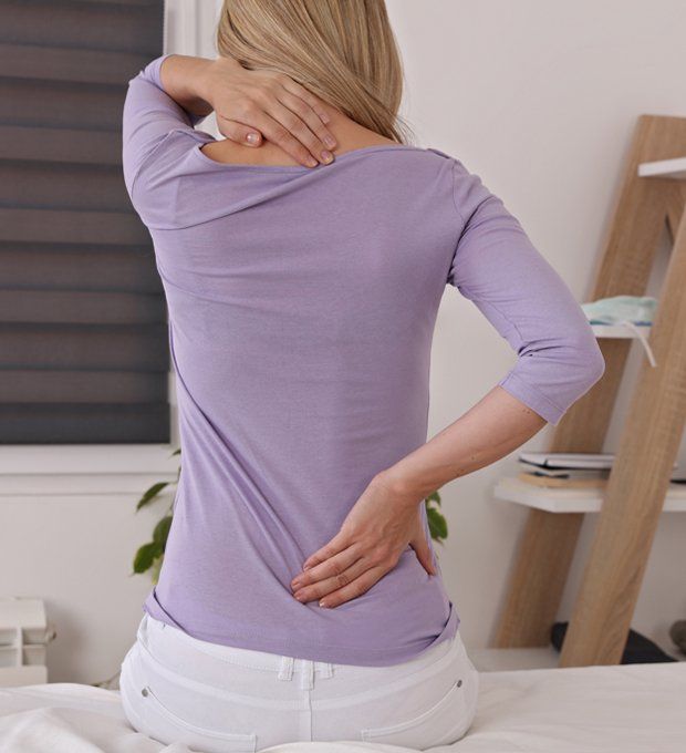 Woman With Back Pain — Monticello, IL — Kruse Chiropractic Clinic