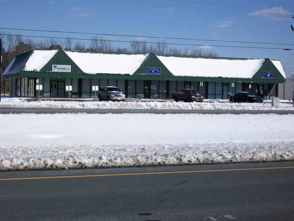 Design Structures — Green Store Covered in Snow in Seaford, DE