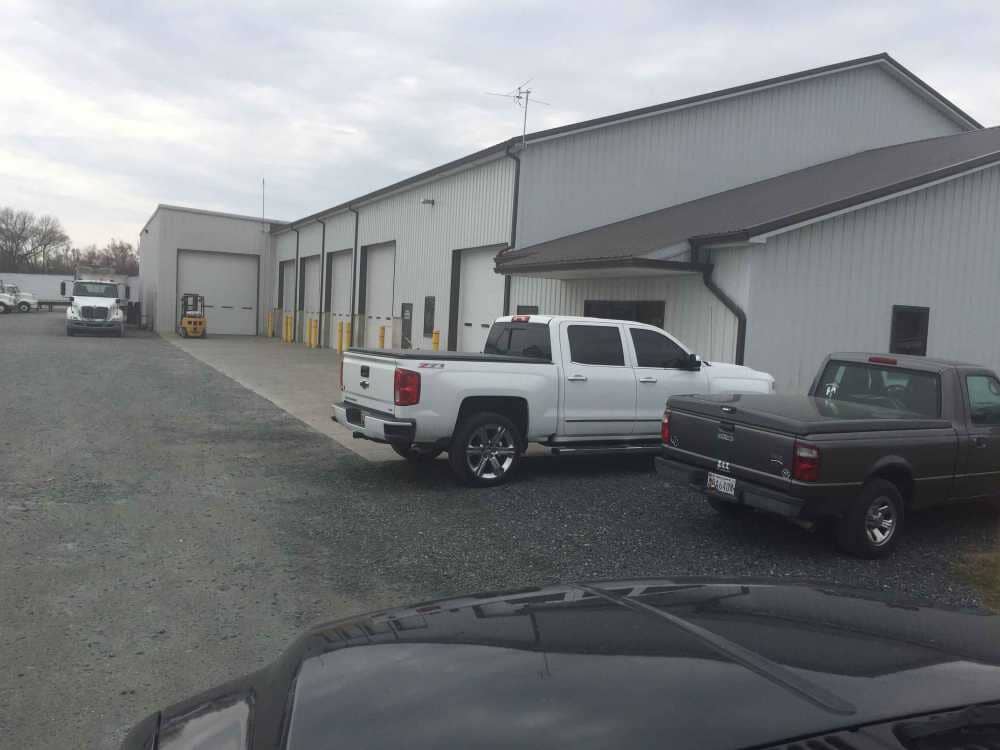 Steel Buildings — Parked Cars Outside A Building in Seaford, DE