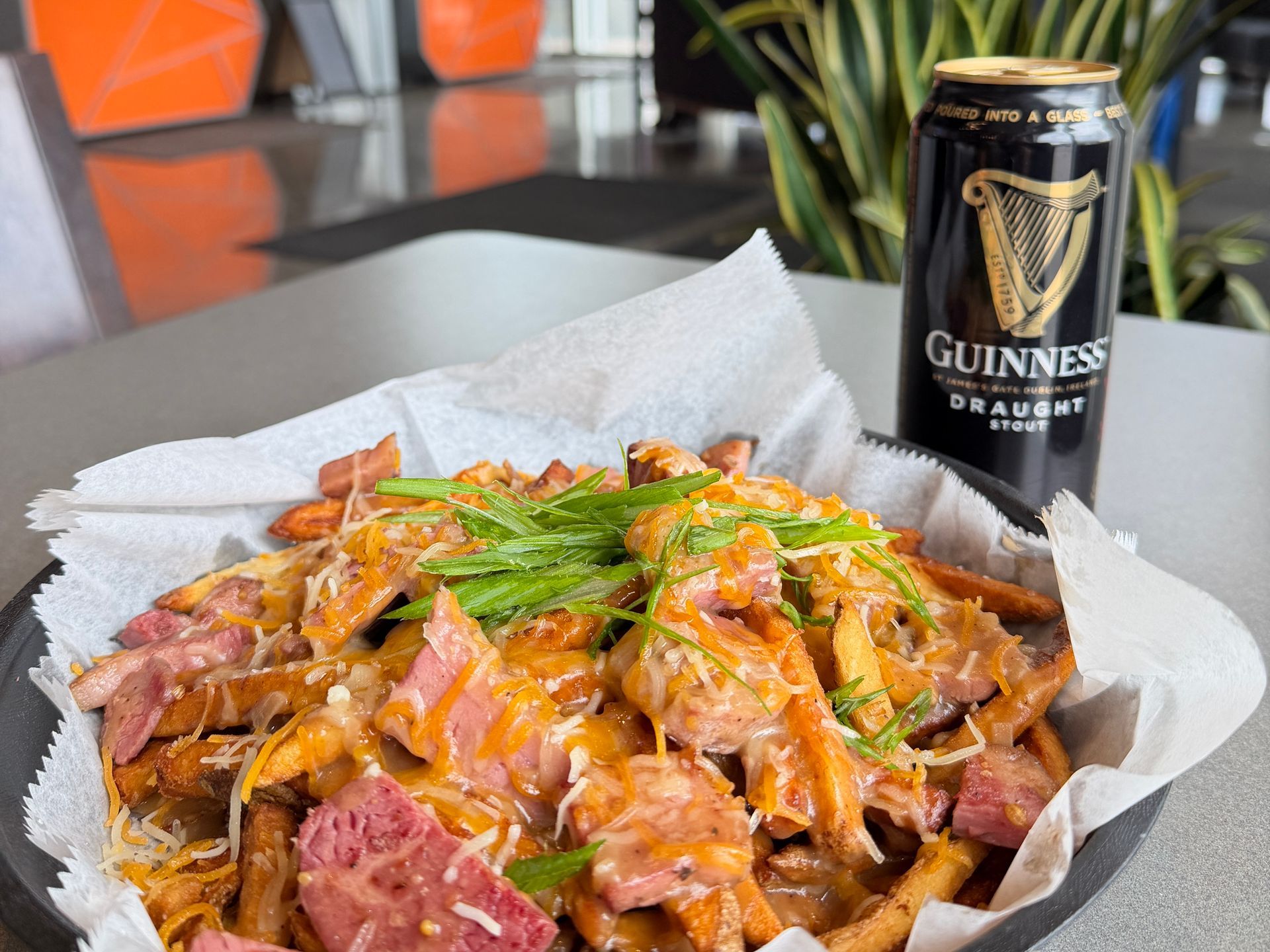 A person is pressing hamburger patties on a grill.