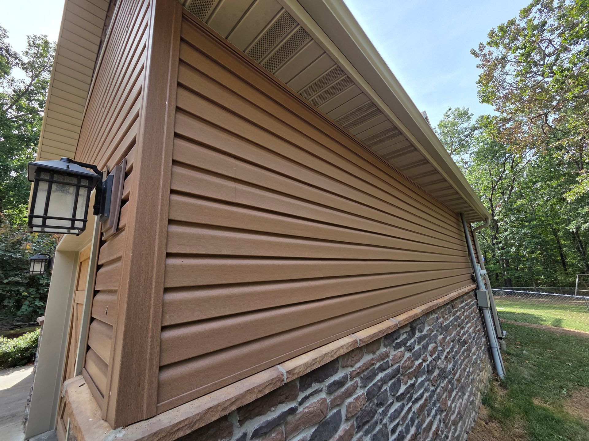 A large house with a brown roof and white trim | Roofing contractor springfield mo