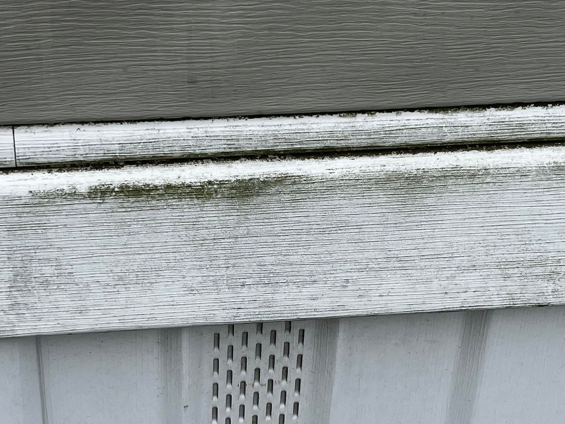 A close up of a white siding on a house.