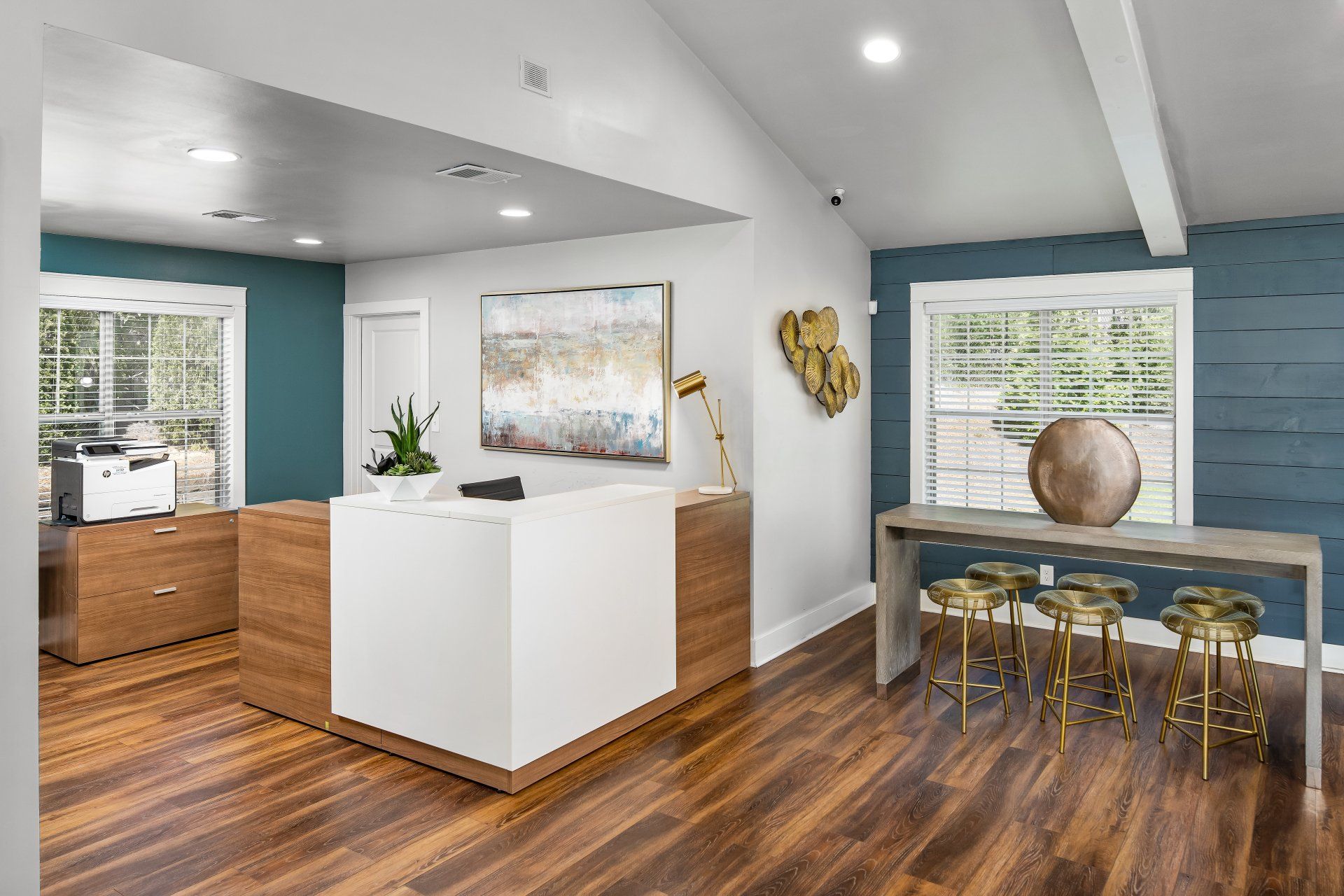 A living room with hardwood floors and a white counter.