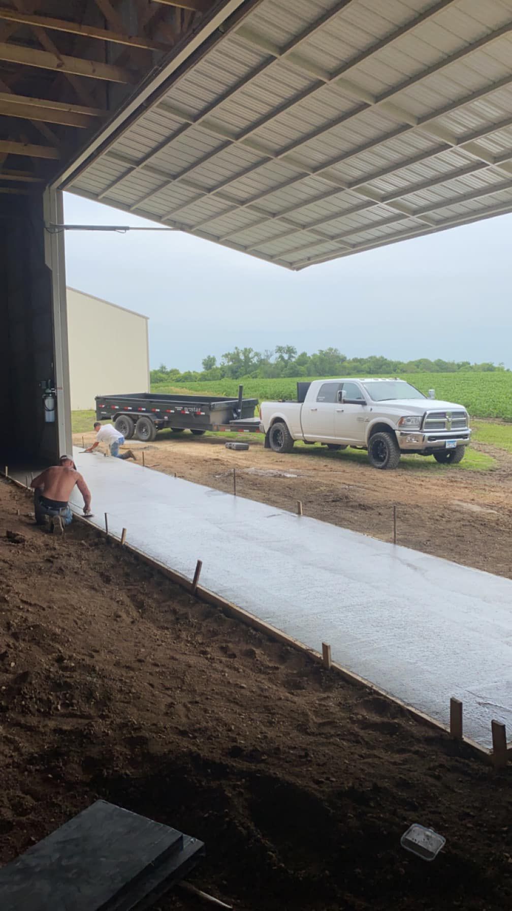 A white truck is parked in front of a building.
