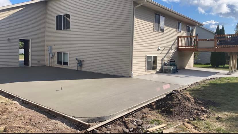 A large house with a concrete driveway in front of it.