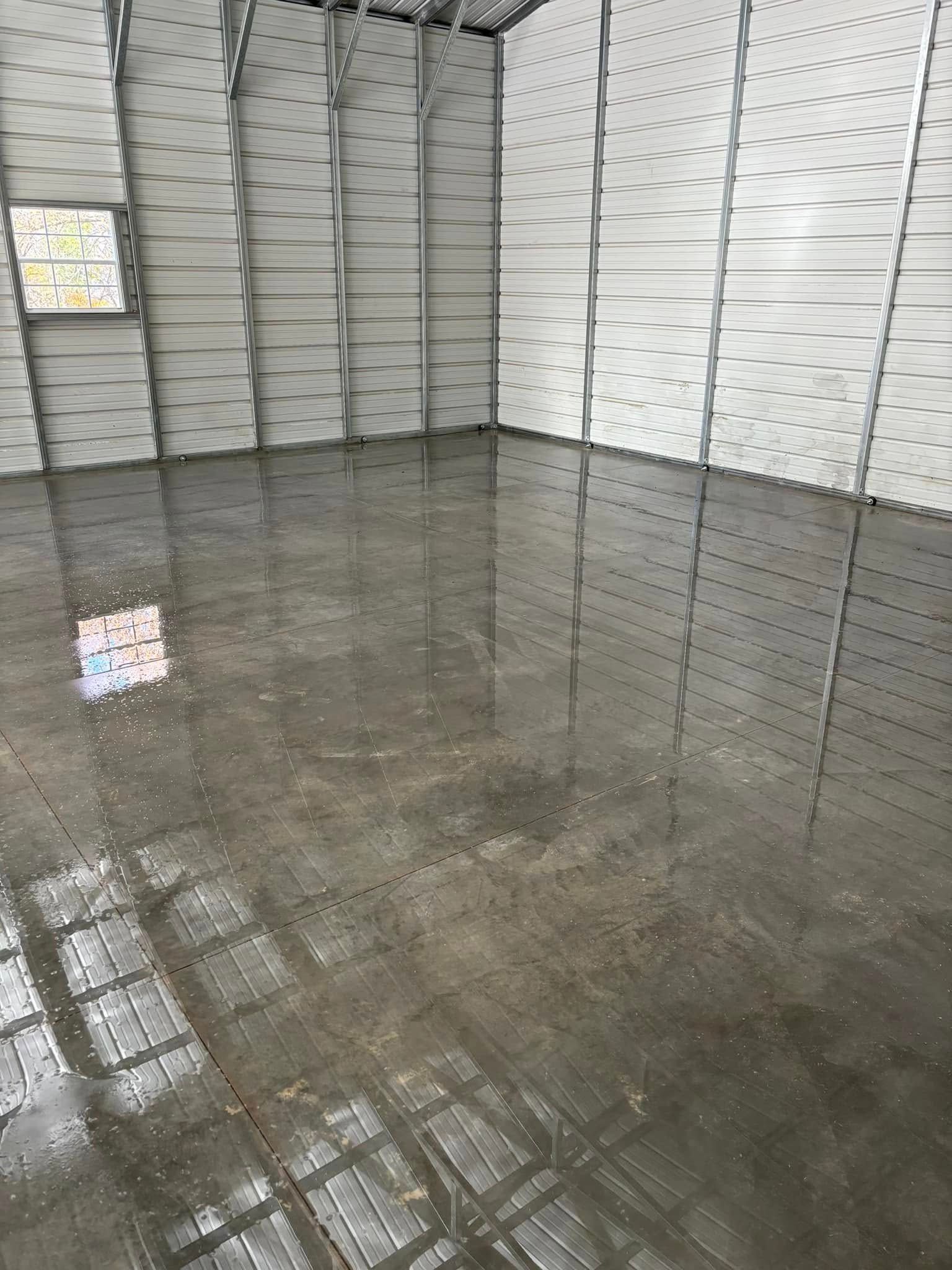 A garage with a shiny concrete floor and white walls.