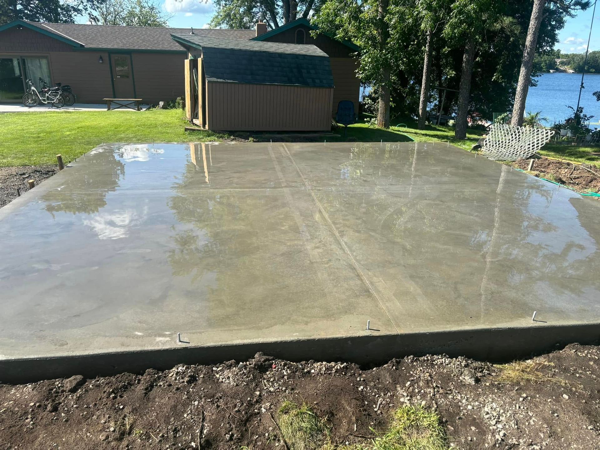 A large concrete slab with a shed in the background