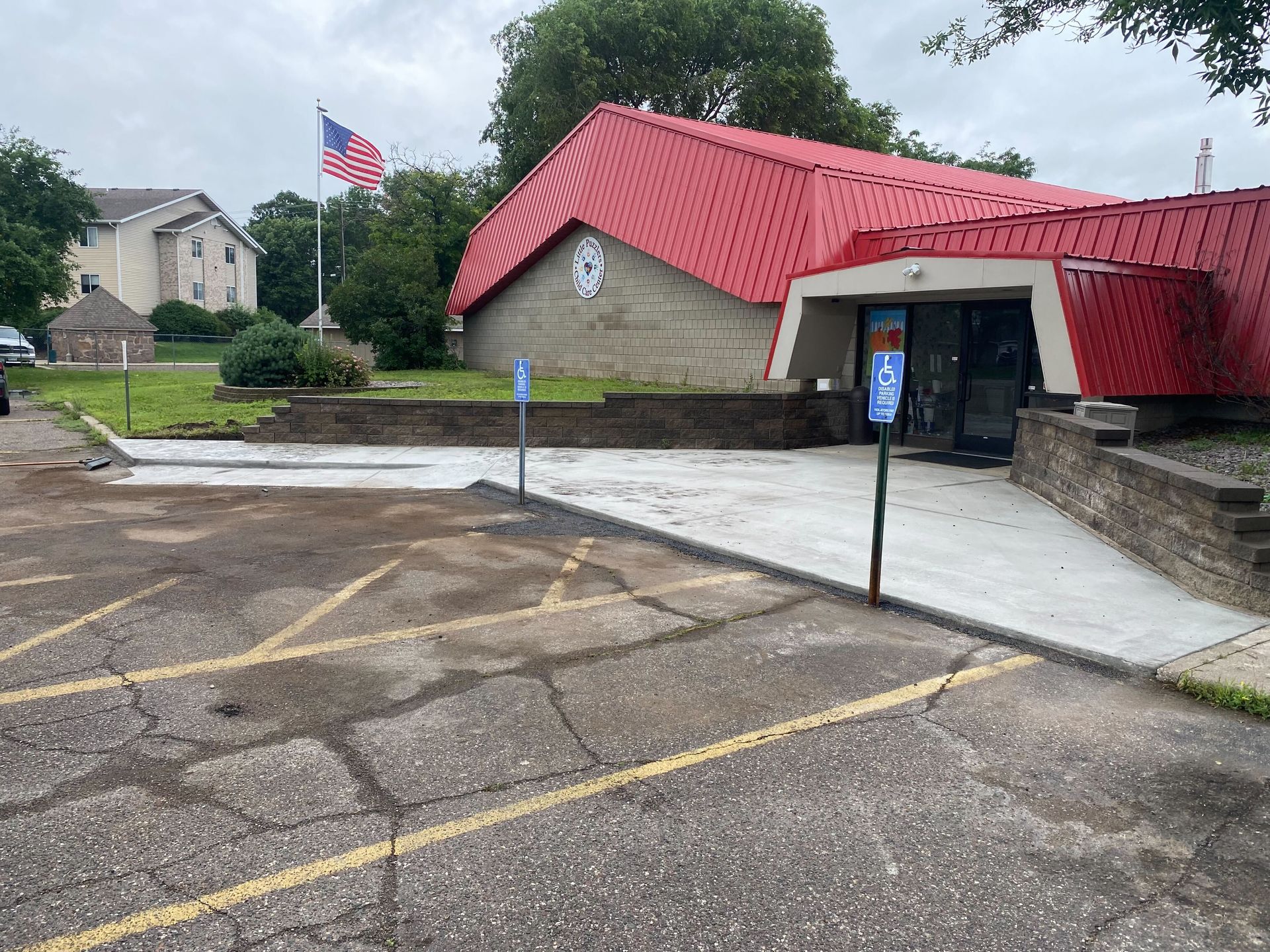 A white house with a concrete walkway in front of it