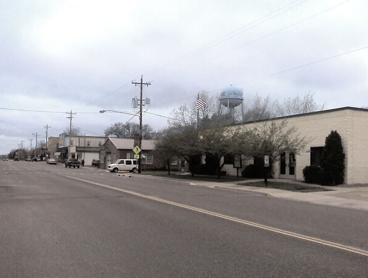 A city street with a water tower in the background