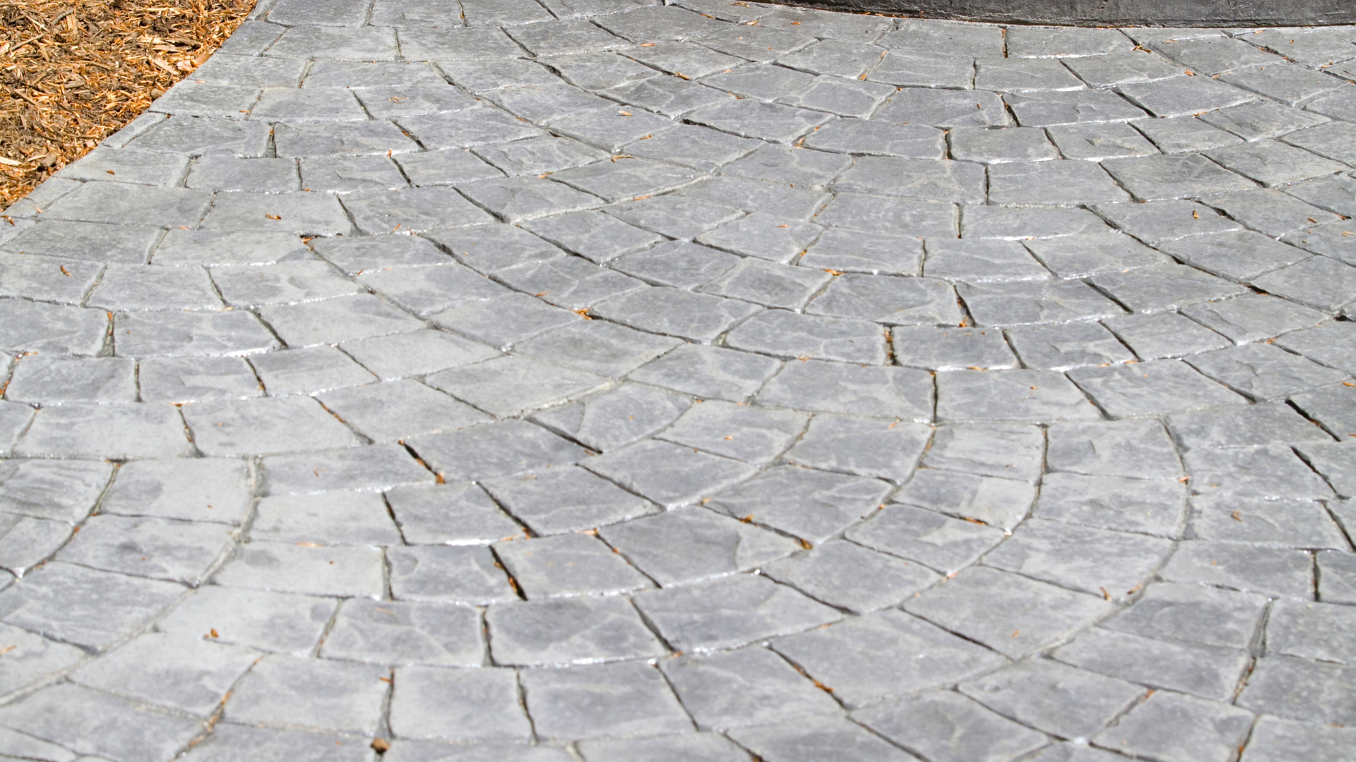 Brick and tile pattern stamped concrete surface designed for a St. Cloud property.