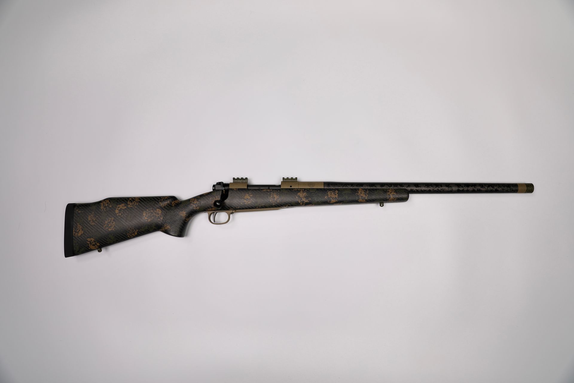 Black and gold camouflage rifle on a white background.
